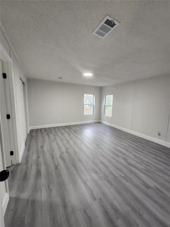 5641 South Butan Point Homosassa, FL 34446 - Photo 5 of 14 wooden floor in an empty room with a window