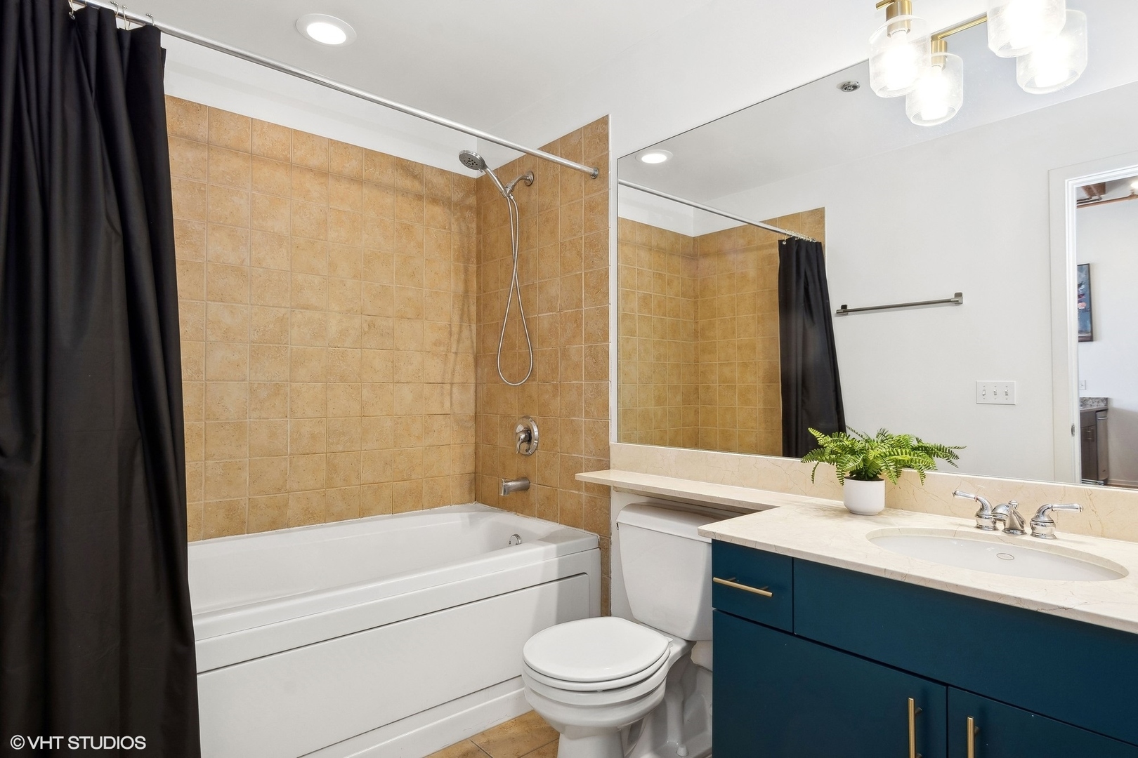 1040 West Adams Street, Unit 473 Chicago, IL 60607 - Photo 12 of 19 a bathroom with a sink a toilet a mirror and shower