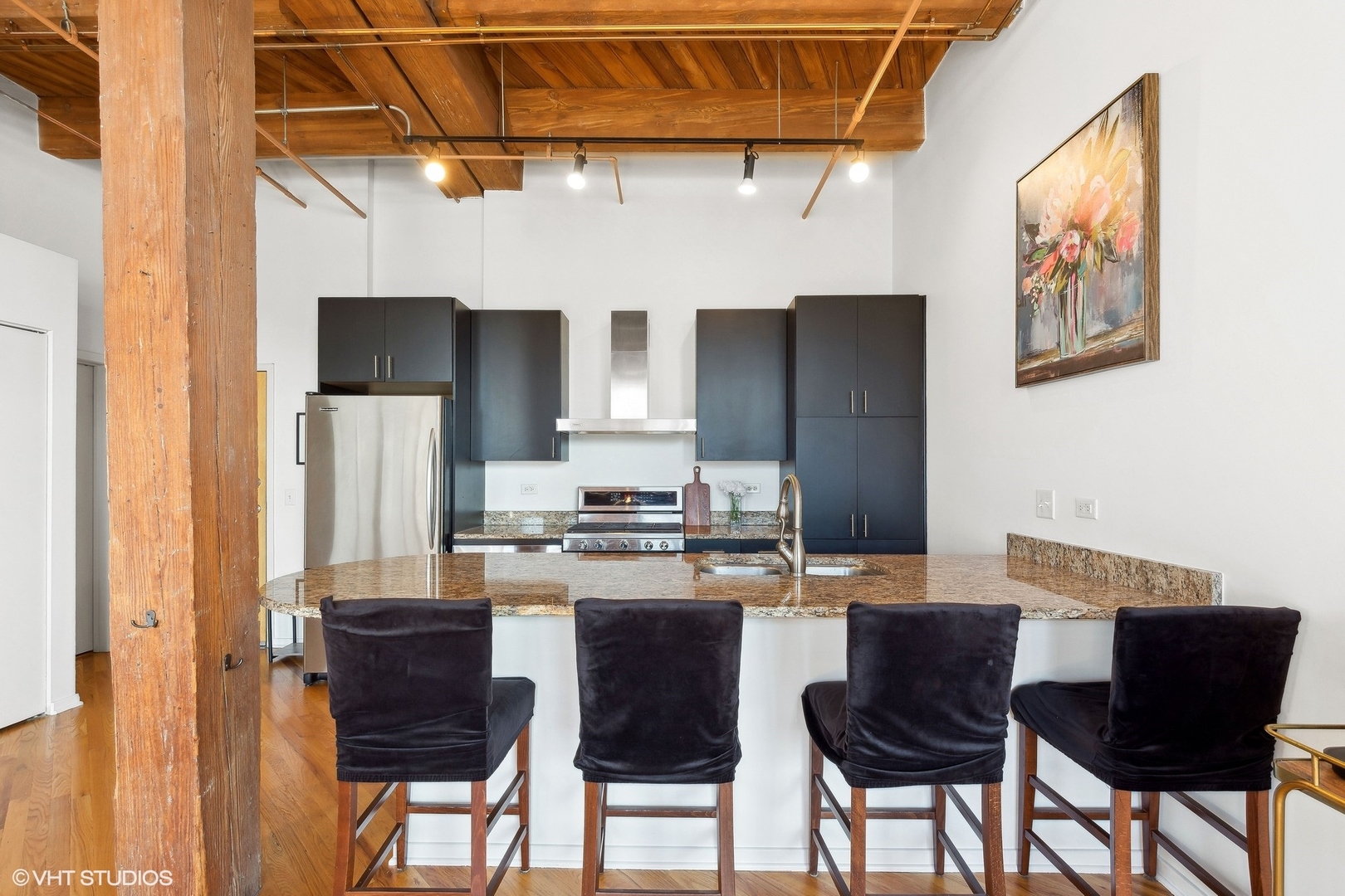 1040 West Adams Street, Unit 473 Chicago, IL 60607 - Photo 7 of 19 a kitchen with a table chairs refrigerator and cabinets