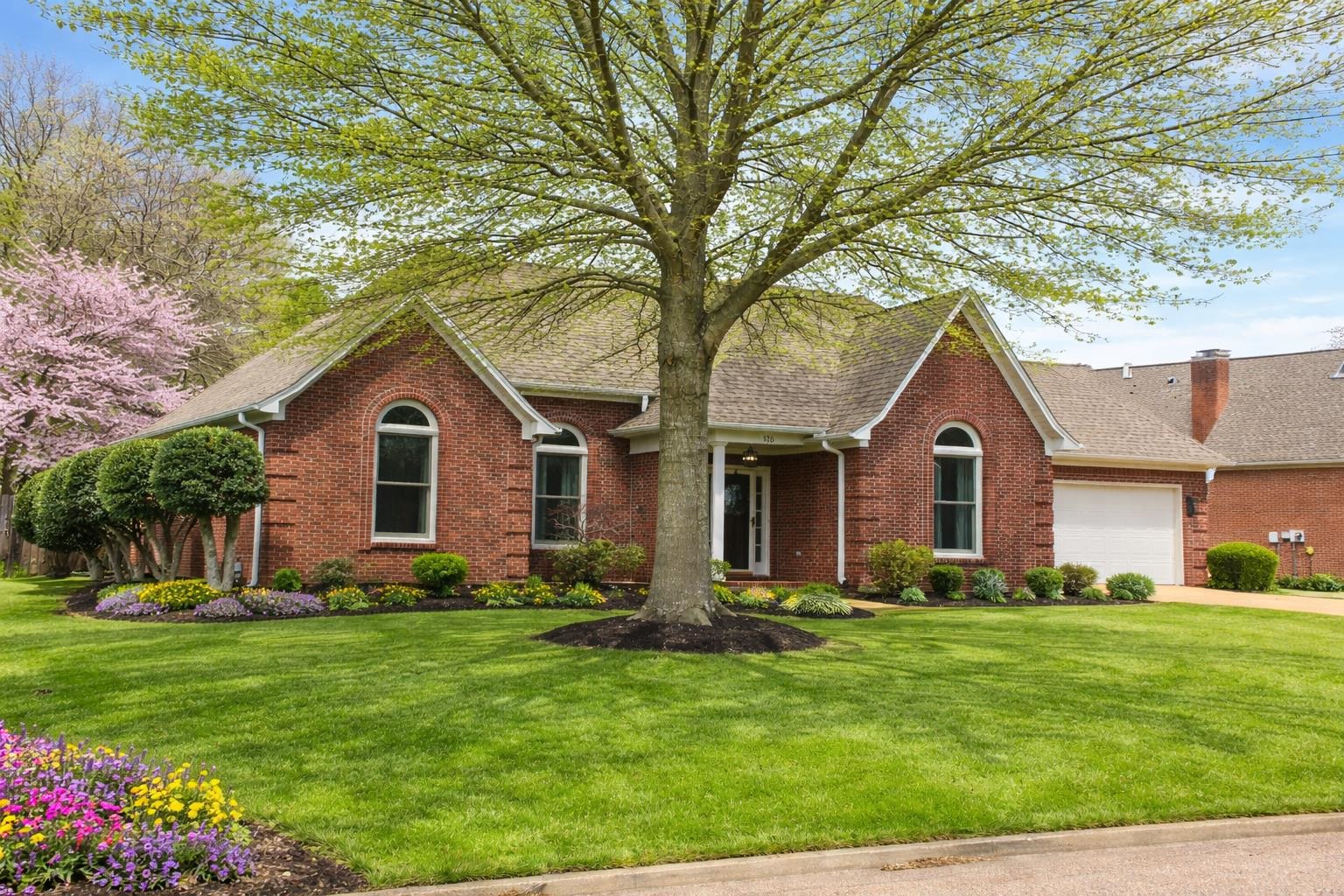 175 Windale Drive Jackson, TN 38305 - Photo 1 of 25 Ranch-style house with brick siding, a front yard, a garage, roof with shingles, and concrete driveway