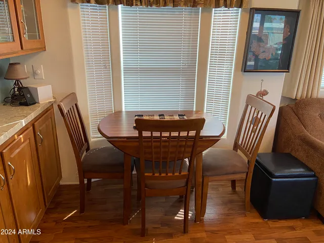 a view of a dining room with furniture window and wooden floor