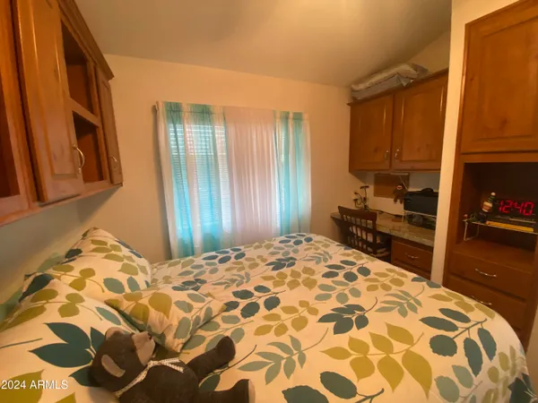 a bedroom with a bed and a mirror