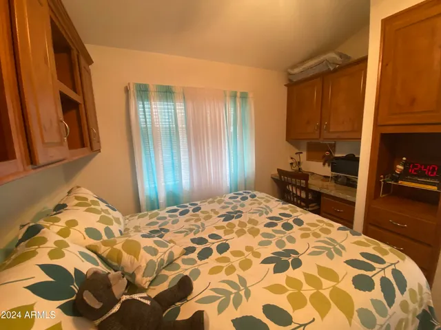 a bedroom with a bed and a mirror