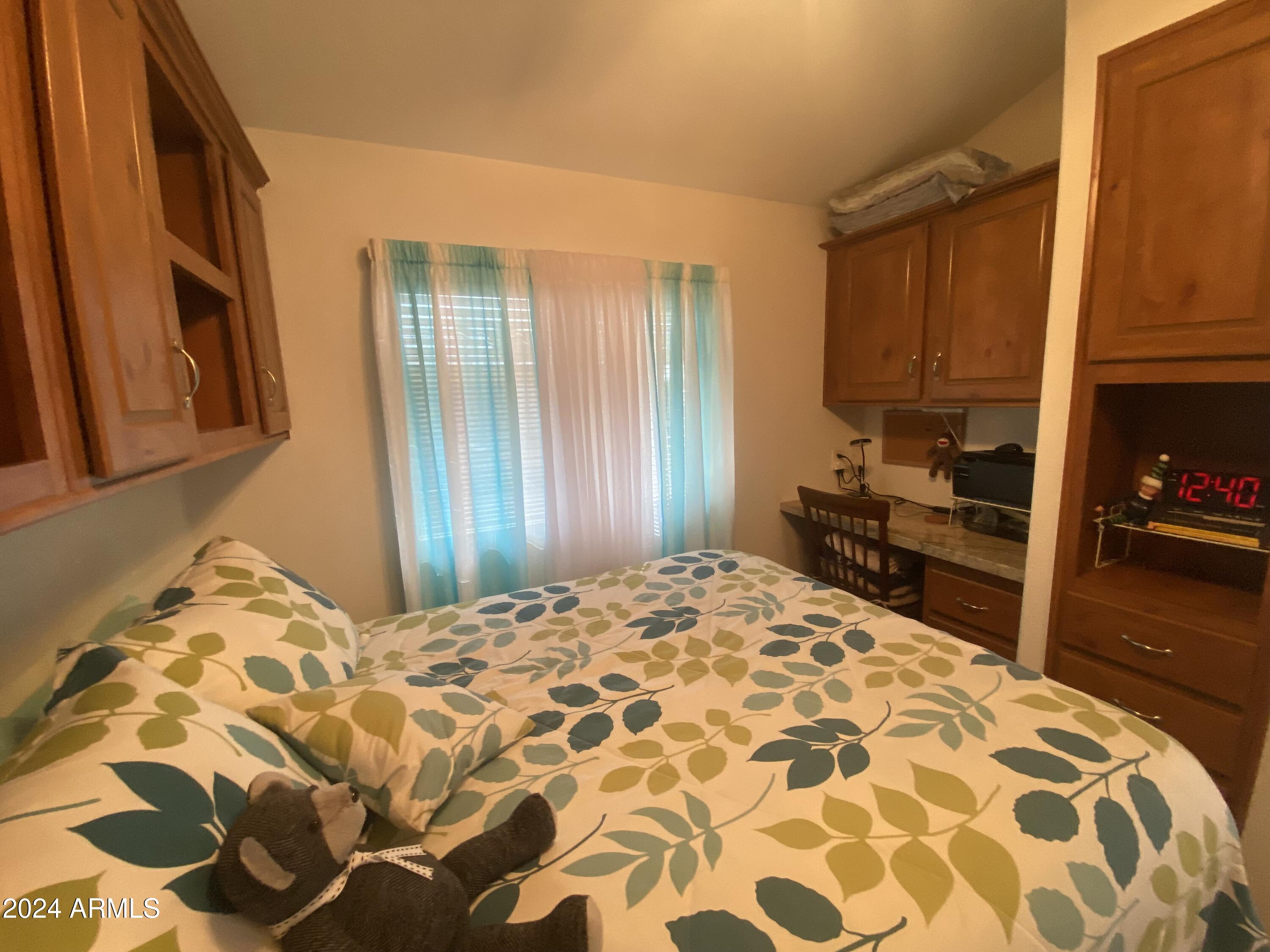 1415 South Havasupai Drive, Unit 415 Apache Junction, AZ 85119 - Photo 19 of 28 a bedroom with a bed and a mirror