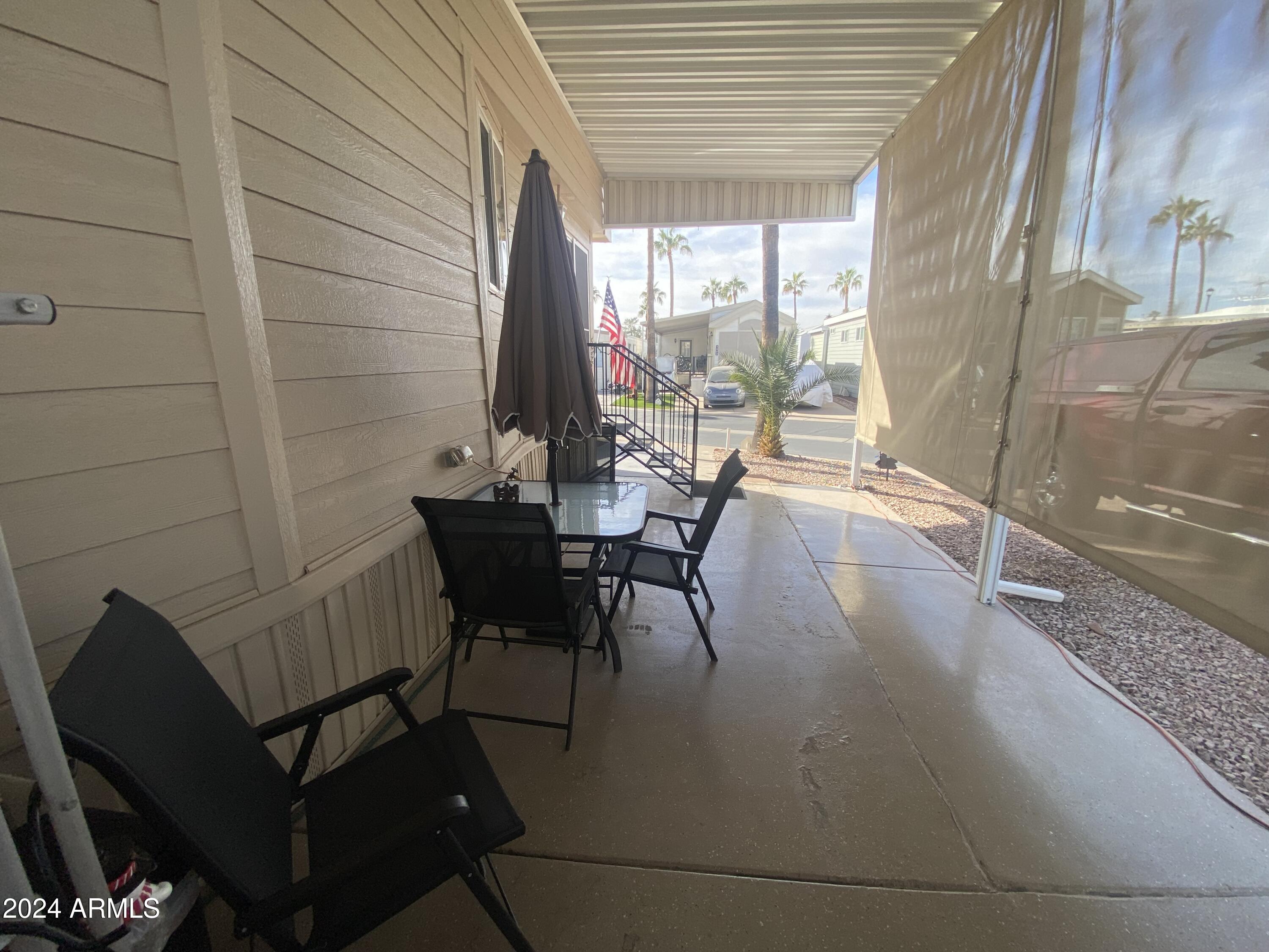 1415 South Havasupai Drive, Unit 415 Apache Junction, AZ 85119 - Photo 26 of 28 a dining room with furniture and wooden floor