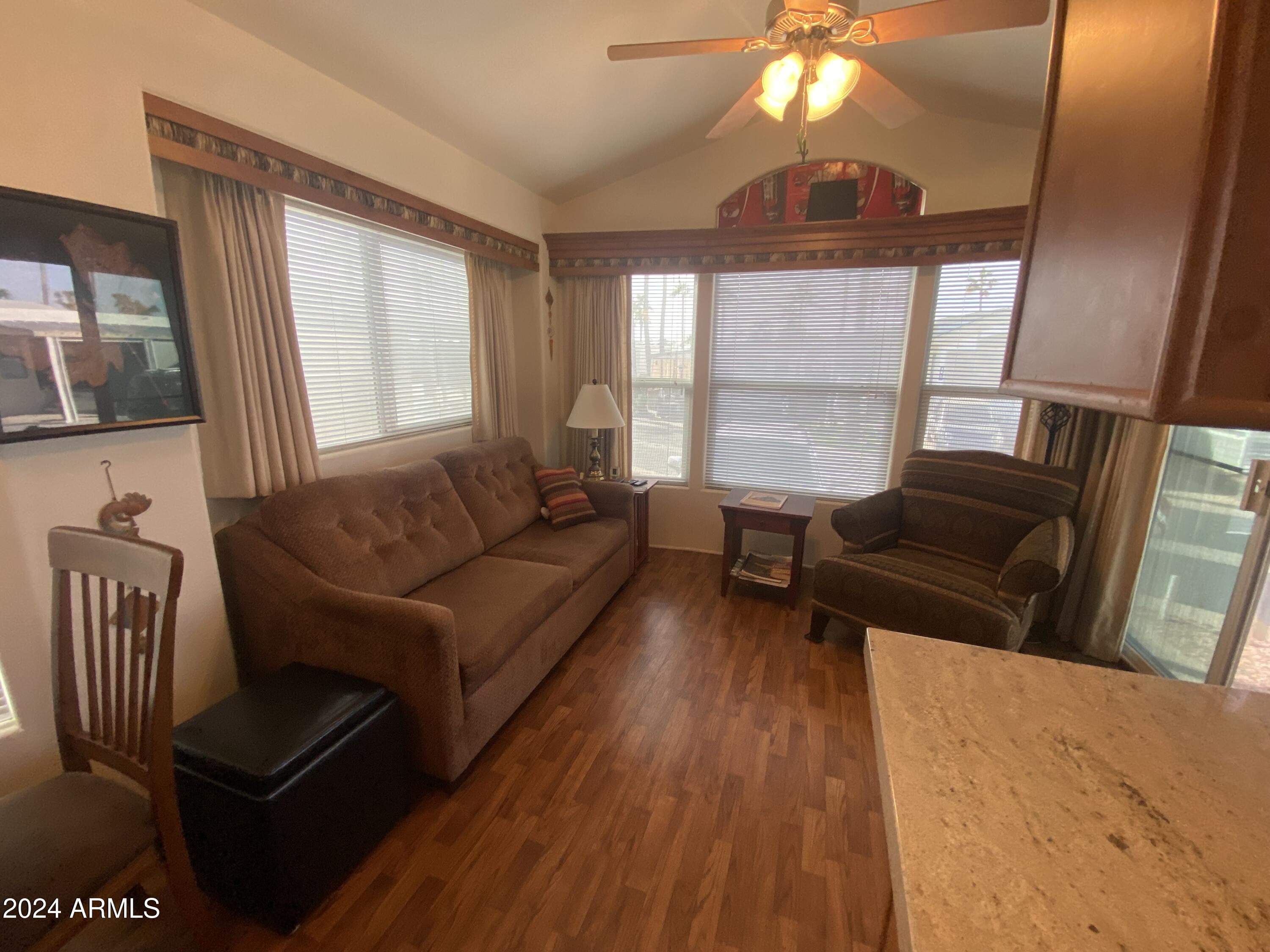 1415 South Havasupai Drive, Unit 415 Apache Junction, AZ 85119 - Photo 3 of 28 a living room with furniture and a large window