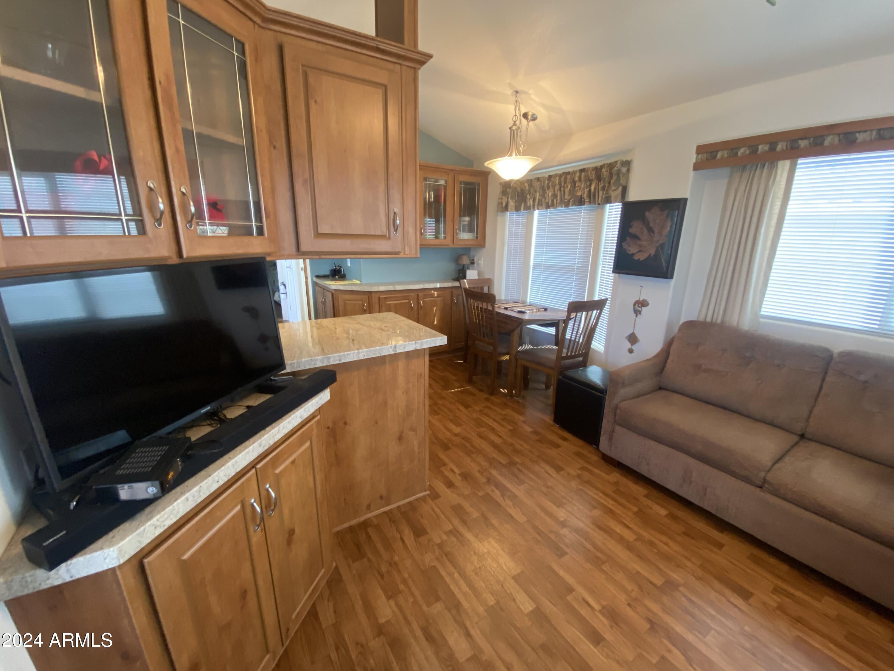 1415 South Havasupai Drive, Unit 415 Apache Junction, AZ 85119 - Photo 6 of 28 a living room with furniture and a flat screen tv