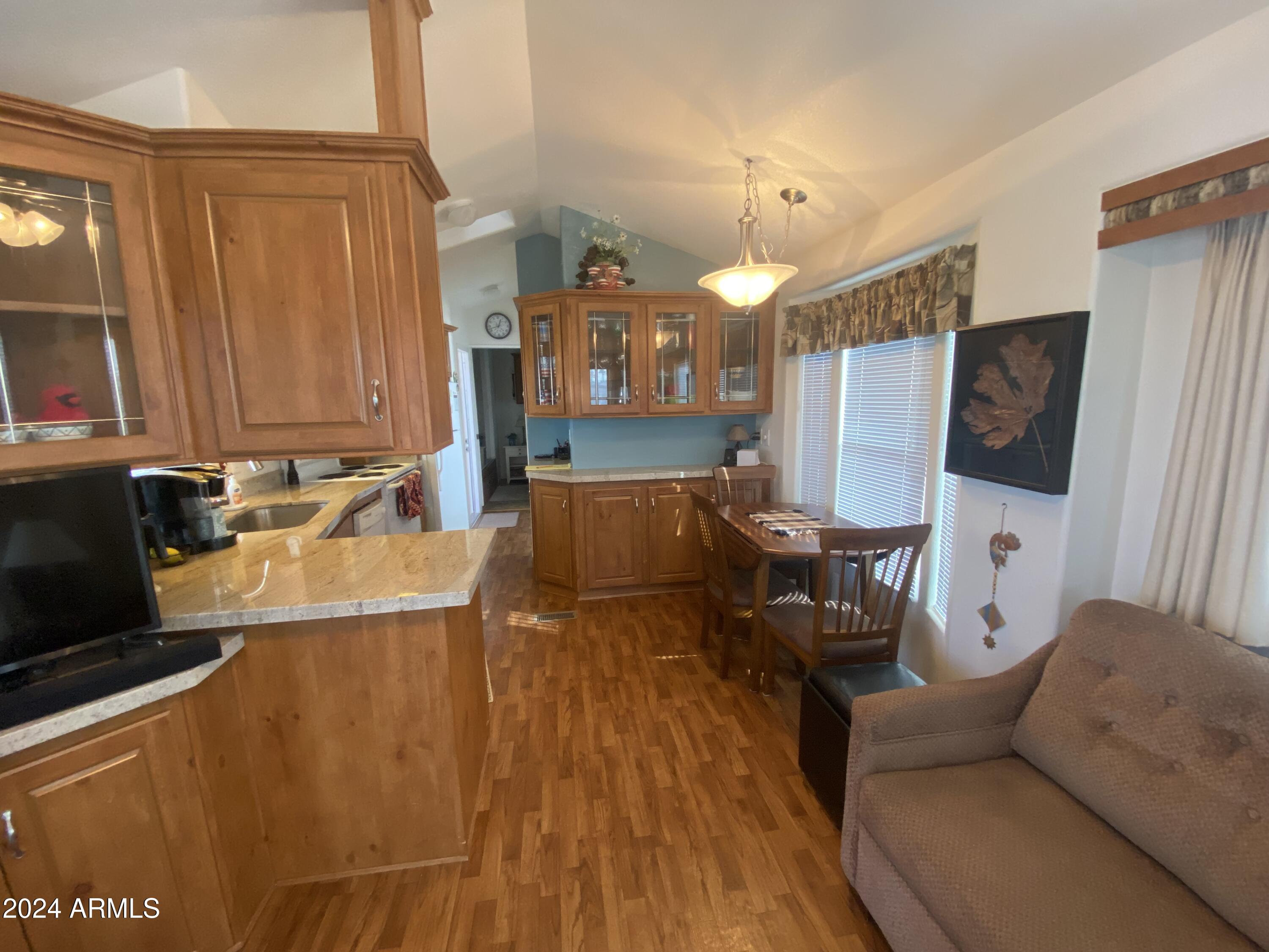1415 South Havasupai Drive, Unit 415 Apache Junction, AZ 85119 - Photo 7 of 28 a living room with furniture and a flat screen tv