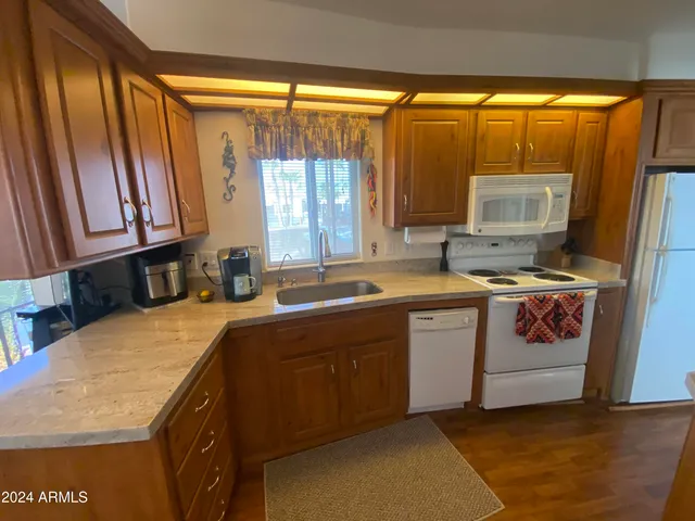 a kitchen with stainless steel appliances a stove a sink and a microwave