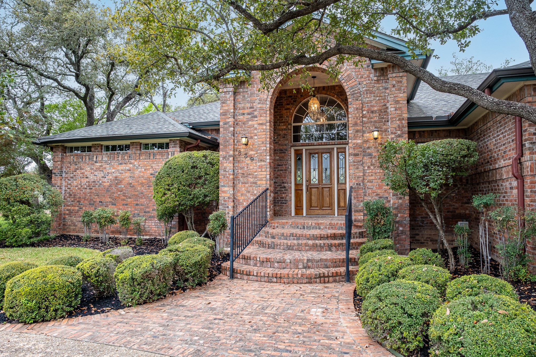 839 Sunfish Street Austin, TX 78734 - Photo 1 of 1 Property entrance featuring brick siding, a shingled roof, and french doors