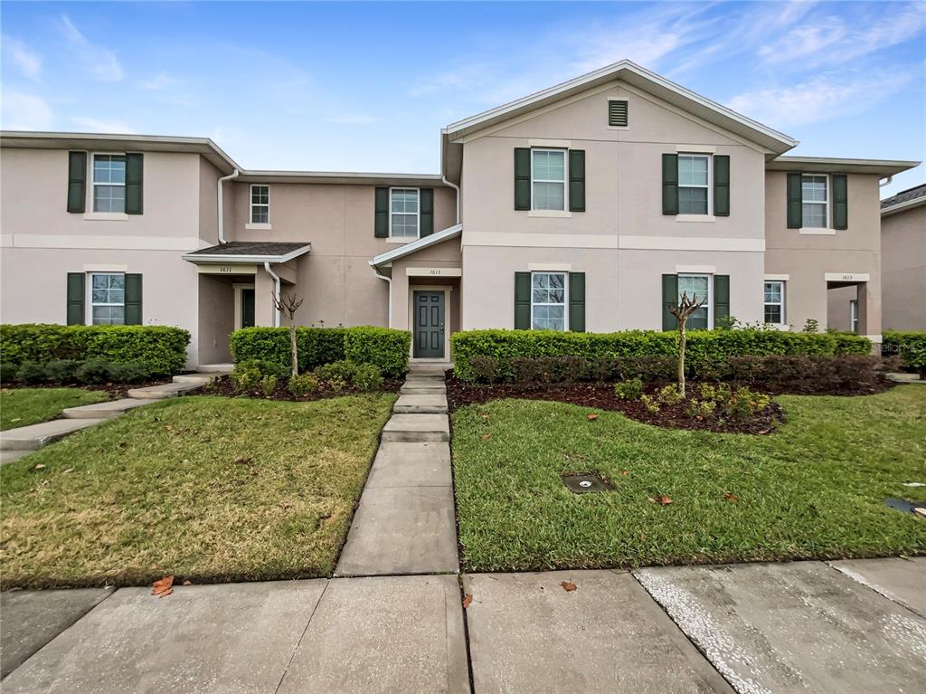 1613 Reflection Cove St. Cloud, FL 34771 - Photo 1 of 1 a view of a yard in front of a house