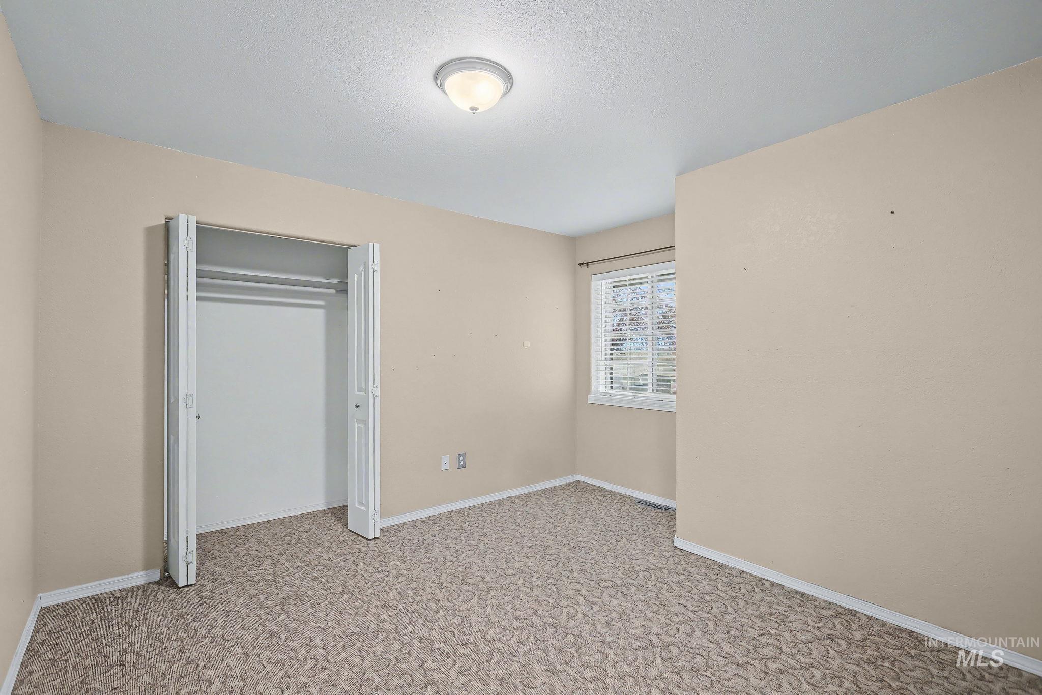 2242 Chukar Lane Clarkston, WA 99403 - Photo 26 of 41 Unfurnished bedroom with a closet and light carpet