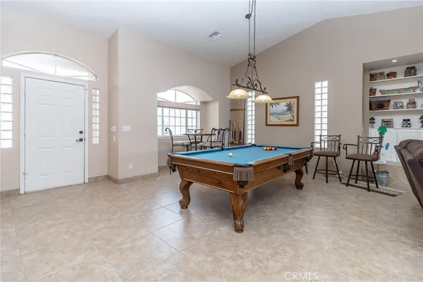 a living room with furniture a table and a chandelier