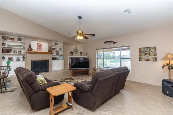 a dining room filled chandelier and wooden floor