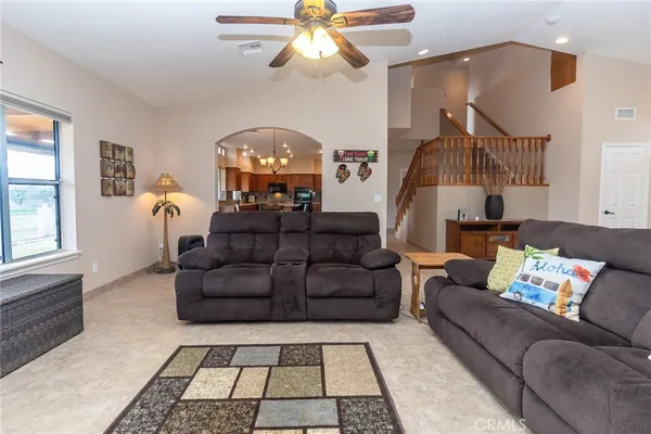 a view of a kitchen with kitchen island granite countertop a large window a sink and counter space