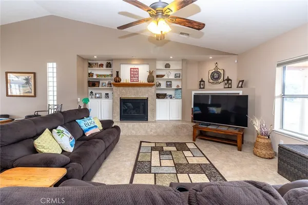 a kitchen with stainless steel appliances granite countertop table chairs sink and cabinets
