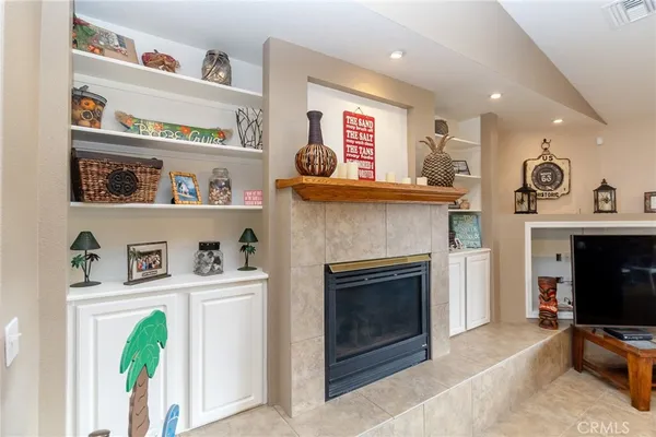 a kitchen with kitchen island granite countertop wooden cabinets and a refrigerator
