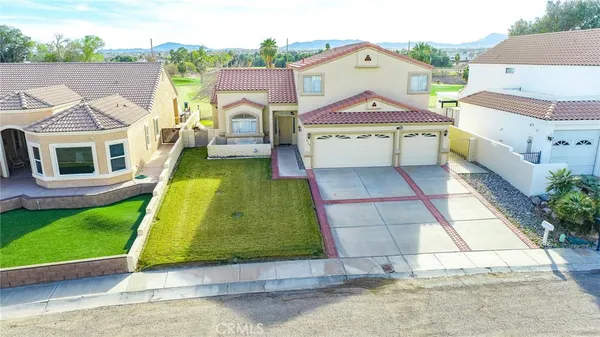 an aerial view of a house with garden space and street view