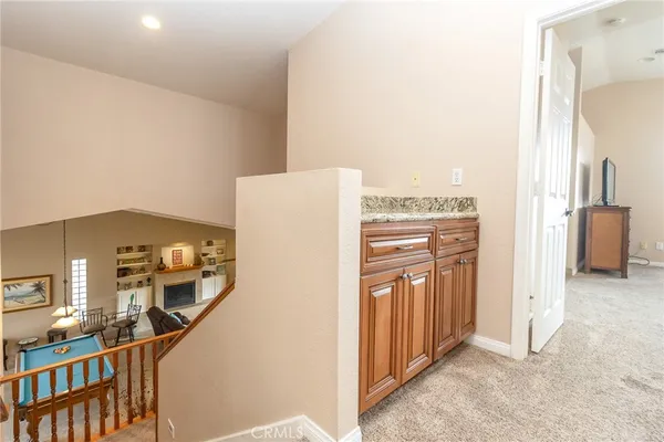 a bathroom with a granite countertop toilet sink and mirror