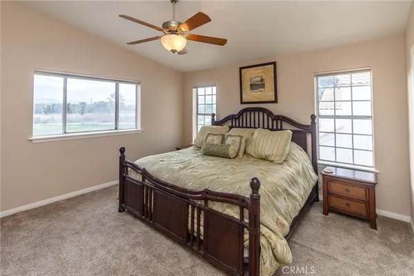 a bathroom with a granite countertop toilet sink and mirror