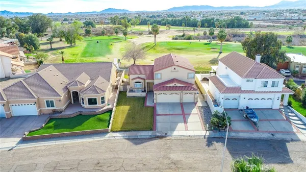 an aerial view of a multi story residential apartment building with swimming pool and sitting space