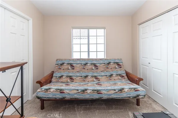 a bathroom with a granite countertop sink a toilet and a mirror