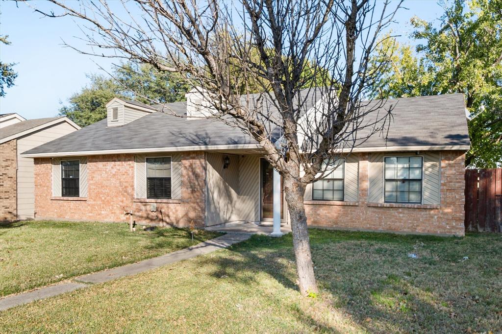 7308 Red Osier Road Dallas, TX 75249 - Photo 1 of 27 front view of house with a yard