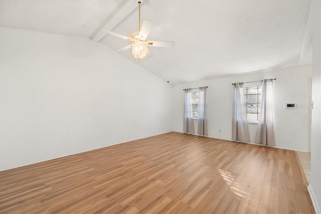 7308 Red Osier Road Dallas, TX 75249 - Photo 12 of 27 a view of an empty room with wooden floor