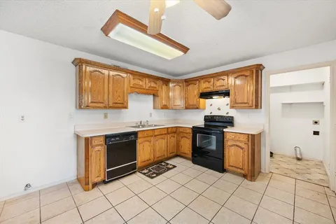 a kitchen with stainless steel appliances granite countertop a stove sink and cabinets
