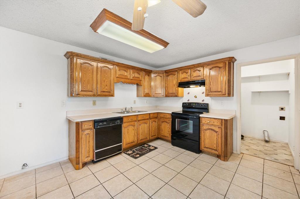 7308 Red Osier Road Dallas, TX 75249 - Photo 14 of 27 a kitchen with stainless steel appliances granite countertop a stove sink and cabinets