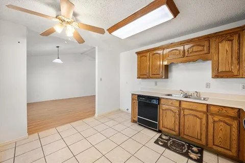 a kitchen with stainless steel appliances a sink cabinets and wooden floor