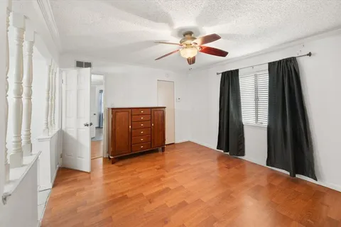 a view of an empty room with window and cabinet