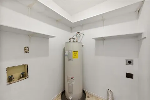 a bathroom with a granite countertop toilet and a sink