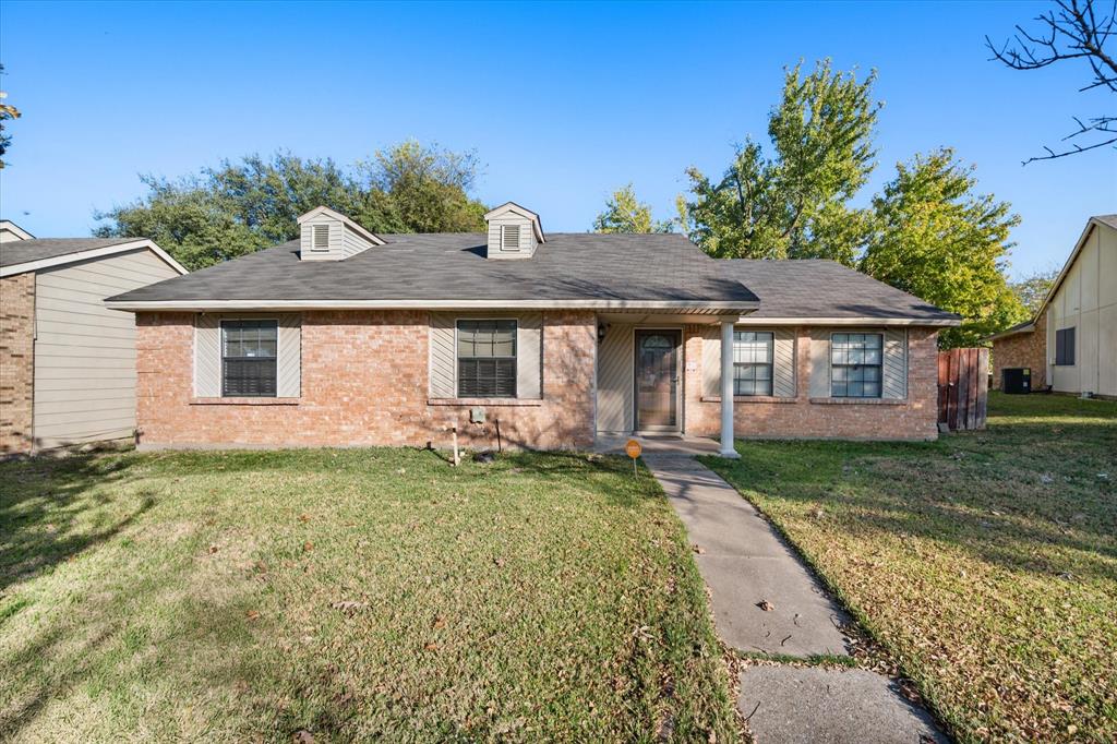 7308 Red Osier Road Dallas, TX 75249 - Photo 5 of 27 a front view of a house with a yard