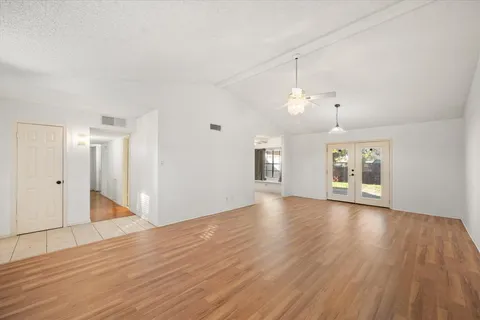 a view of a room with wooden floor and window