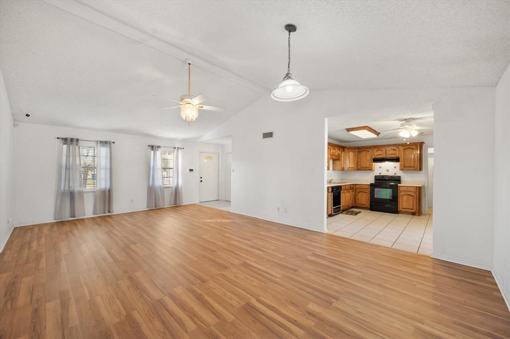 7308 Red Osier Road Dallas, TX 75249 - Photo 10 of 27 a view of empty room with wooden floor and window