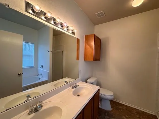 a bathroom with a sink a toilet and mirror
