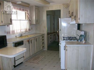 6480 Katherine Road, Unit 63 Simi Valley, CA 93063 - Photo 3 of 12 a kitchen with stainless steel appliances granite countertop a stove a refrigerator and a sink