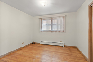 5705 West Higgins Avenue, Unit 1 Chicago, IL 60630 - Photo 8 of 12 an empty room with a window