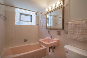 5705 West Higgins Avenue, Unit 1 Chicago, IL 60630 - Photo 9 of 12 a bathroom with a sink a toilet and shower