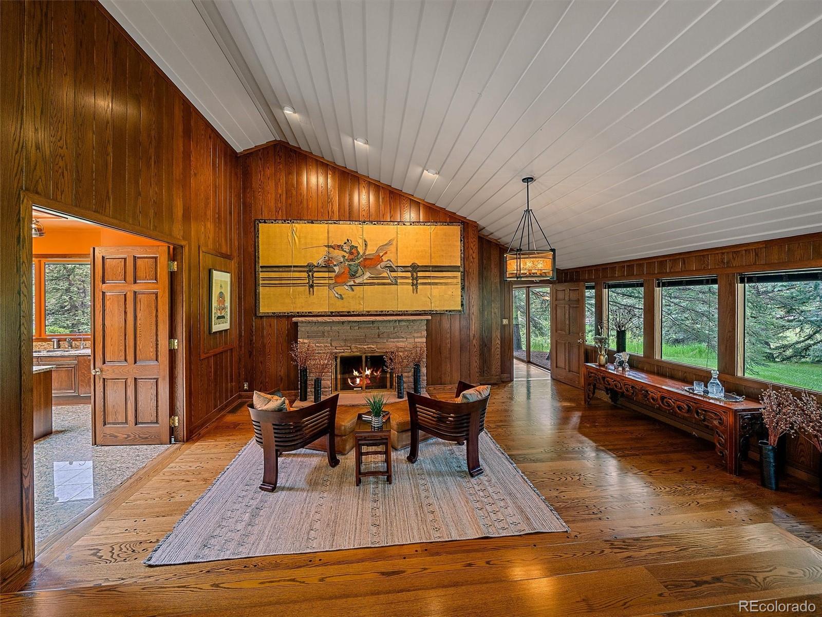 32453 Upper Bear Creek Road Evergreen, CO 80439 - Photo 17 of 48 a living room with furniture and a large window