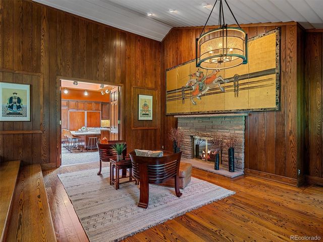 a living room with furniture a fireplace and a chandelier