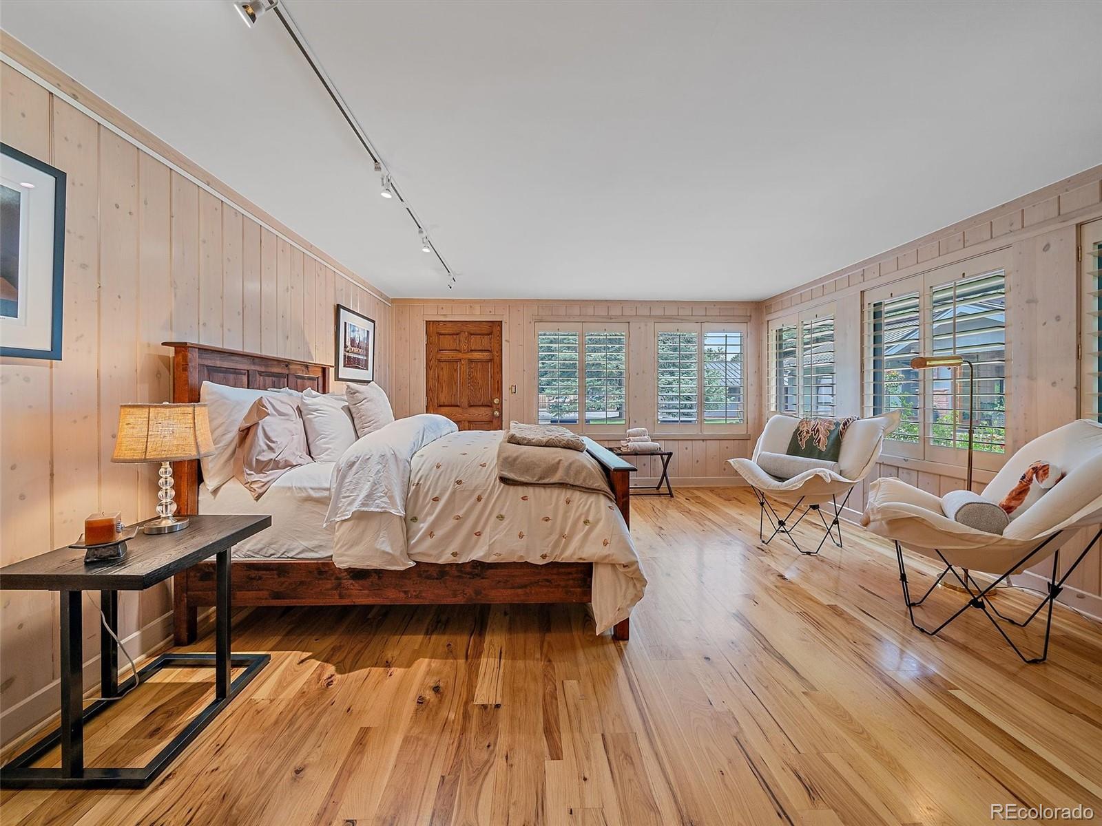 32453 Upper Bear Creek Road Evergreen, CO 80439 - Photo 23 of 48 a living room with furniture and a wooden floor