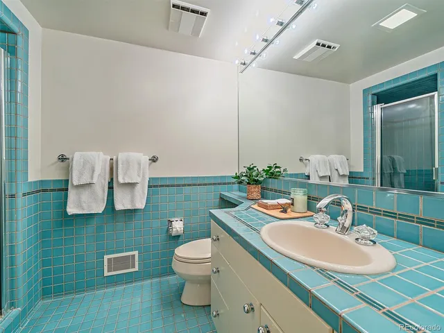 a bathroom with a sink toilet and mirror