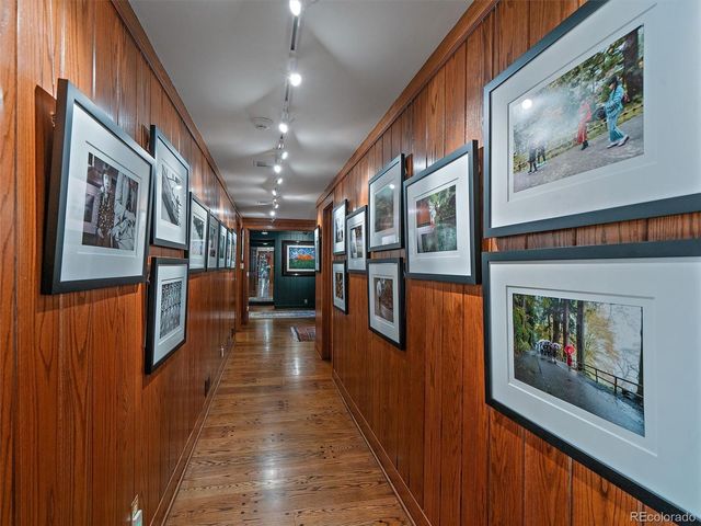 a hallway with wooden floor fireplace and furniture