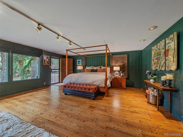 a bedroom with a large bed and a large window