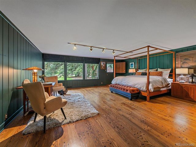 a bedroom with a bed and large window