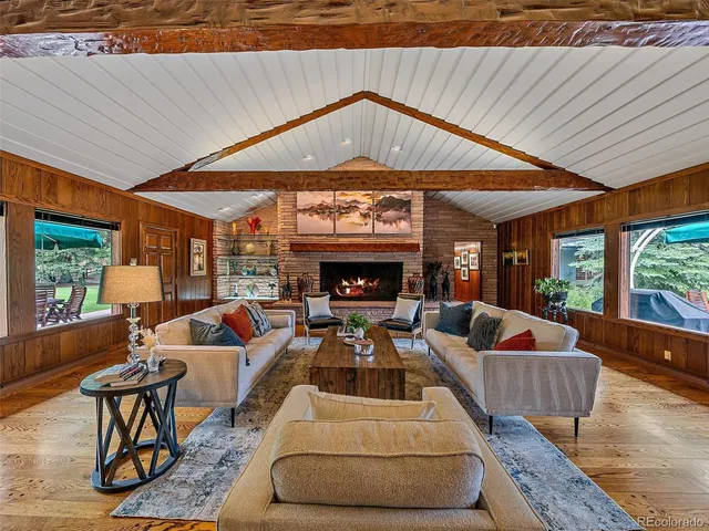 a living room with furniture a fireplace and a table