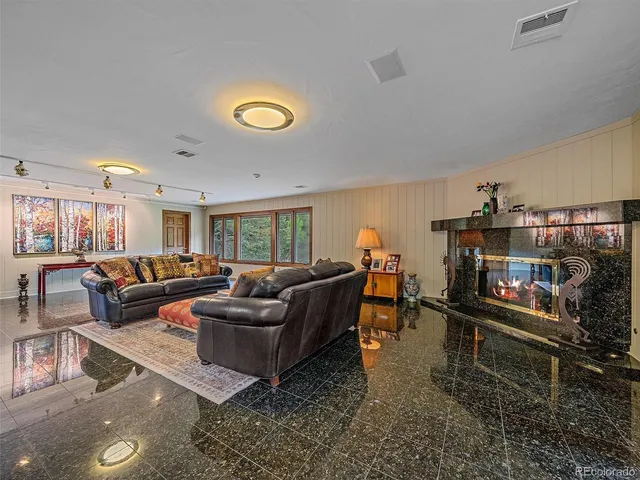 a room with pool table and windows