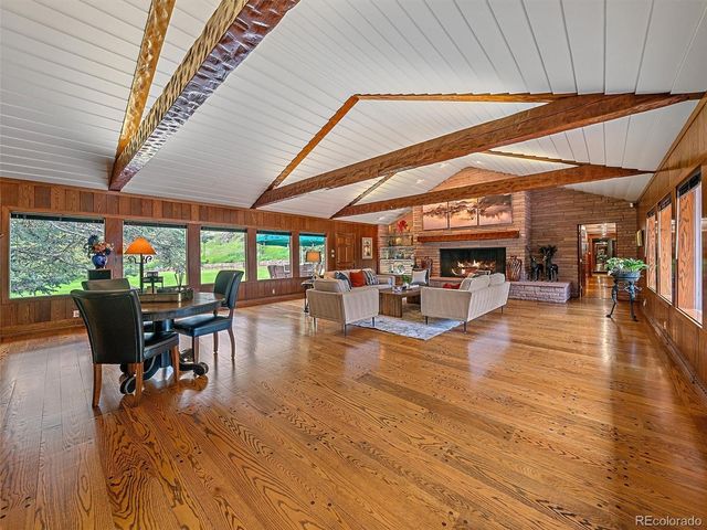 a view of a patio with dining table and chairs with wooden floor